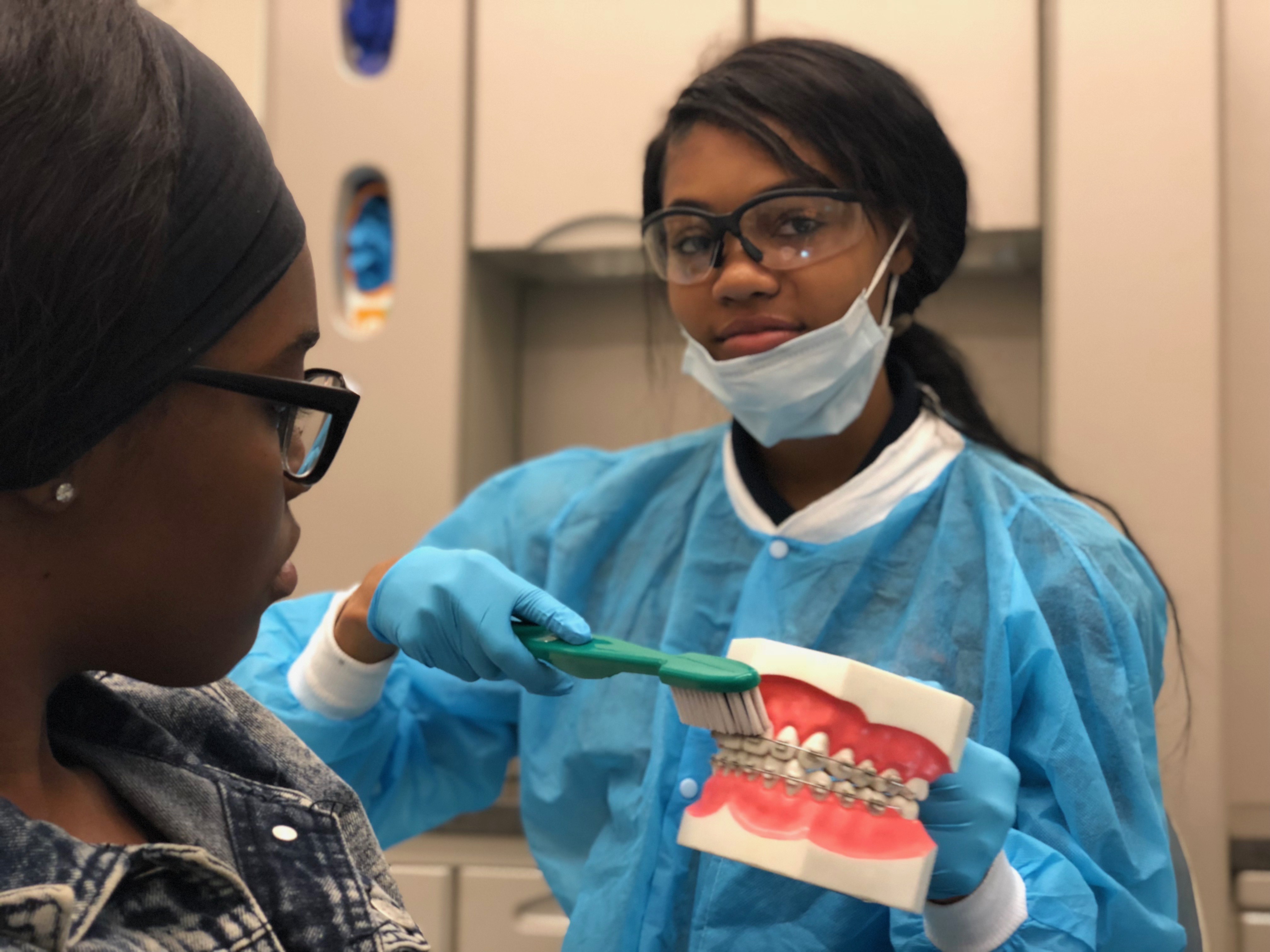Dental assisting students teach oral health to their peers.